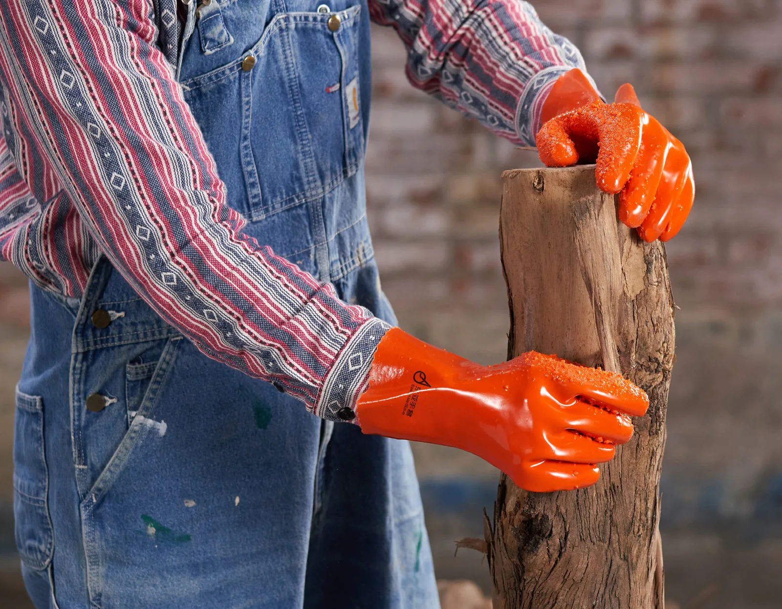 Orange 807-series PVC gloves gripping timber in a material-handling scene