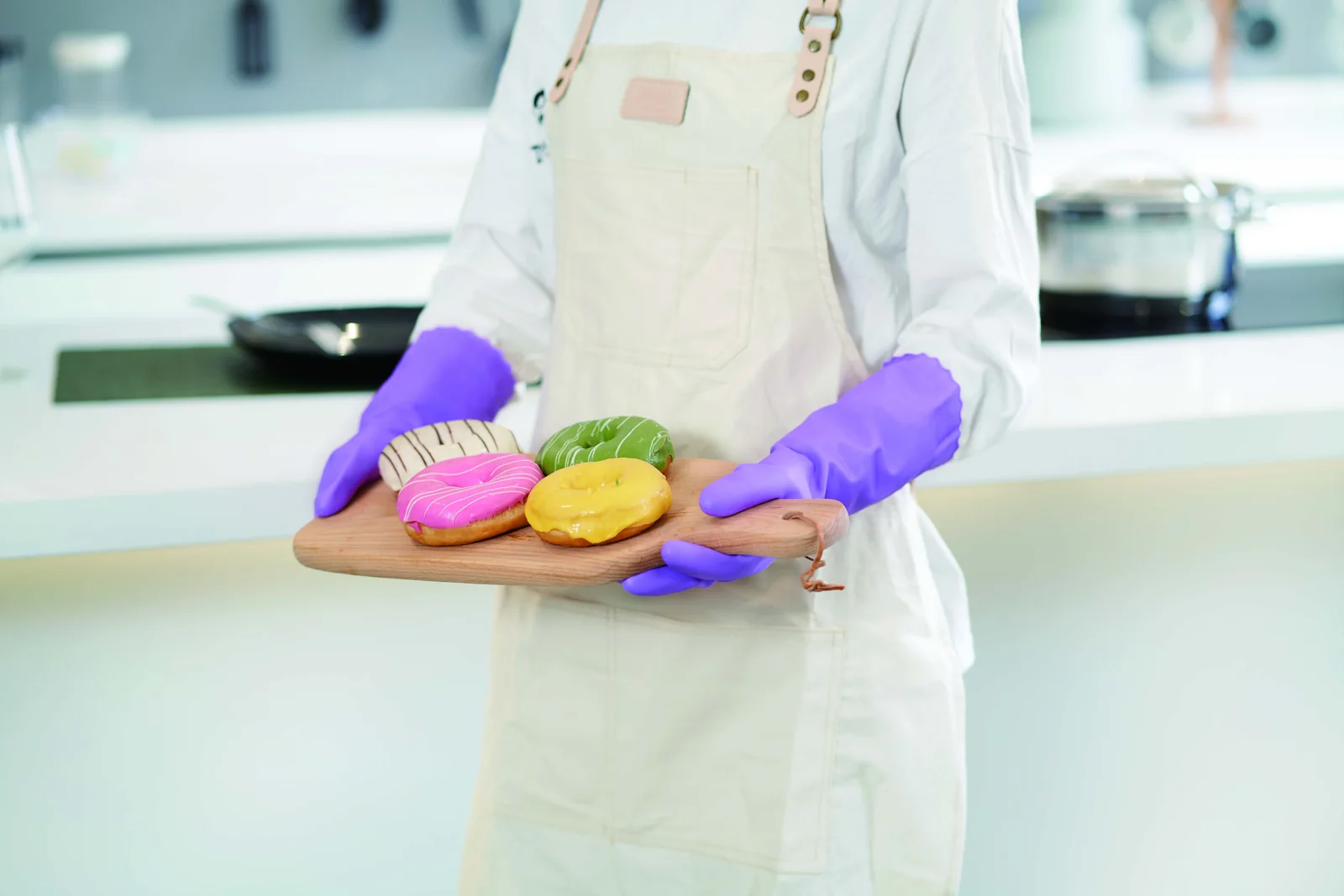 Purple 808 household gloves shown with a tray of pastries in a kitchen