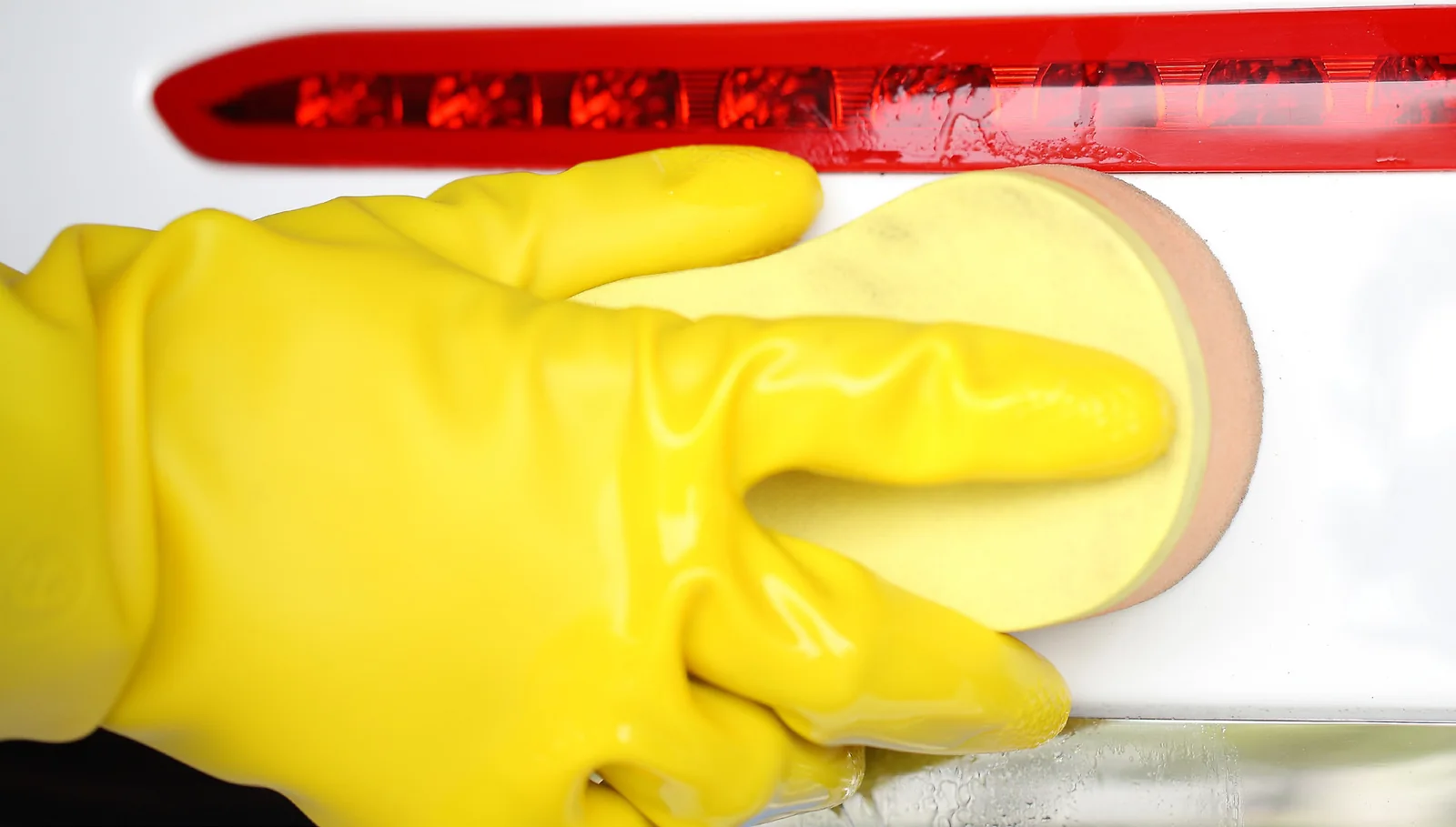 Yellow A32 PVC gloves cleaning a white surface with a sponge in the supplied OEM catalog